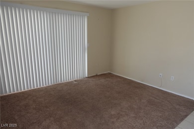 Carpeted empty room with baseboards