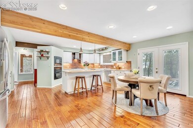 Dining area featuring recessed lighting, light wood finished floors, french doors, and beamed ceiling