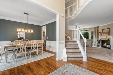 Two story foyer opens to dining room.