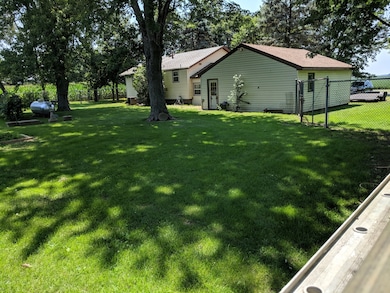 Back of garage and house from within the fenced ya