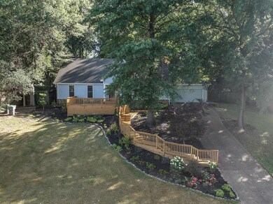 View of yard featuring a wooden deck and a garage