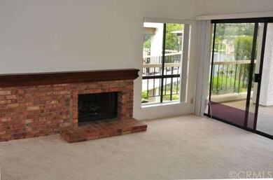 The expansive raised-hearth, brick FP in the LR