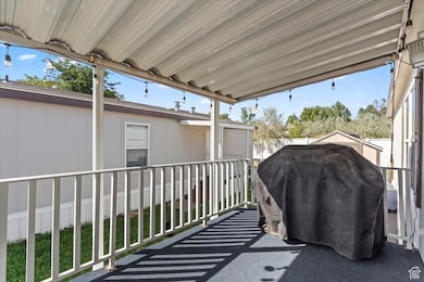View of patio featuring grilling area and a sunroom