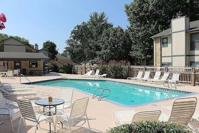 Community pool with fence and a patio area