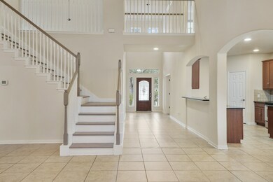 The view of the light & airy two story entryway.