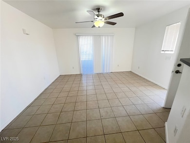 Unfurnished room featuring ceiling fan, light tile