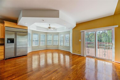 Eat in kitchen with coffered ceiling and fan with 