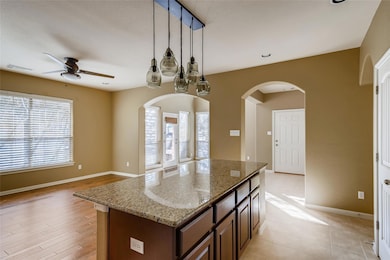 Kitchen featuring a kitchen island, baseboards, a