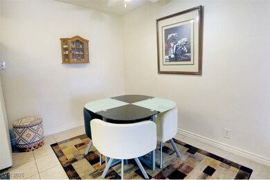 Dining area with light tile patterned flooring and a ceiling fan