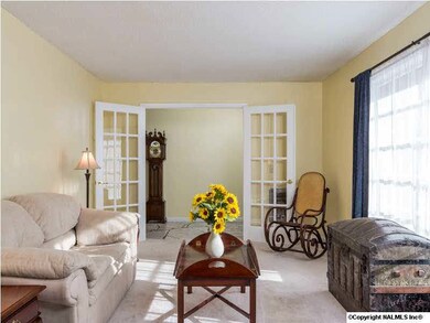 Just off the foyer is a set of french doors that lead into the formal living room.