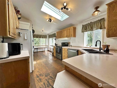 Kitchen with eating space, coffee nook, airy atmosphere, and abundant daylight from numerous windows.