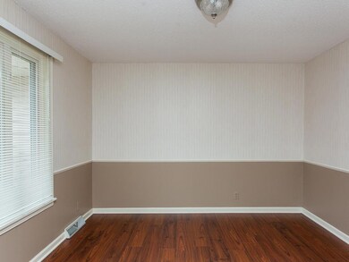 SPECTACULAR Dining Room boasts STUNNING wood floors, chair rail and PLENTY OF ROOM to serve those marvelous family and/or friend dinners!