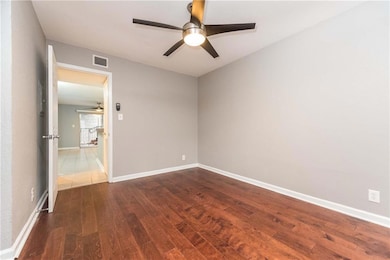Unfurnished room with a ceiling fan and wood fini