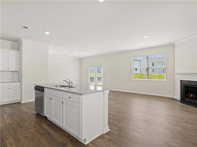Kitchen with white cabinets, a kitchen island with