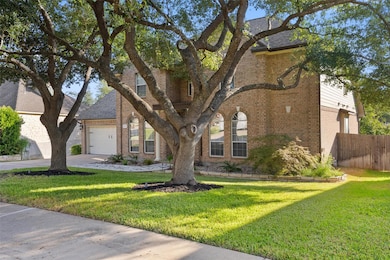 An illustrious front yard accentuated by tall trees that provide an abundance of shade, making it easy to sit out and wave to passing neighbors.