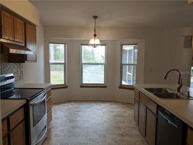 Eat-in Kitchen with tile backsplash and vaulted ce