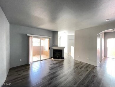 Unfurnished living room featuring arched walkways,