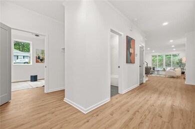 Hallway with LVP flooring, recessed lighting, baseboards