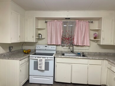 Large Country kitchen with lots of storage. The door that leads to a large expansive deck.