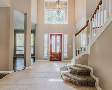 Entryway with living room and office to the left a