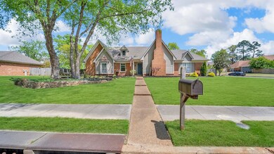 View of front of home featuring fence, a front law