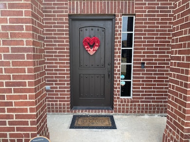 Covered entry with charming solid wood door.