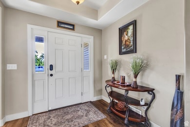 Foyer featuring baseboards and wood finished floors