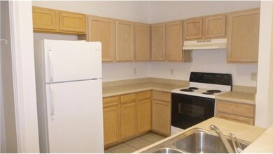 Kitchen featuring freestanding refrigerator, unde