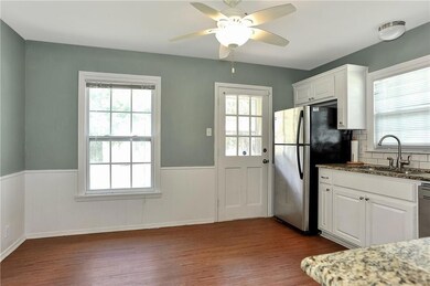 Kitchen with white cabinets, appliances with stainless steel finishes, and sink