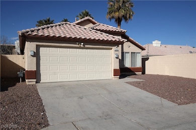 View of front of home with driveway, a tile roof,
