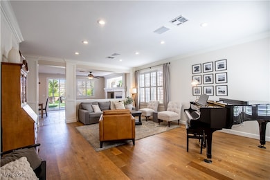 Living area featuring baseboards, visible vents, o