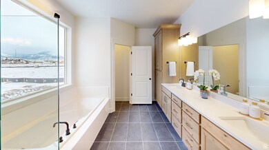 Full bathroom with tile patterned flooring, double vanity, a bath, and healthy amount of natural light