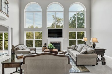 Great room has cozy gas fireplace surrounded by windows!