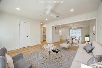 Living room featuring ceiling fan and light hardwood / wood-style flooring