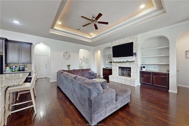 Living room with a ceiling fan, crown molding, a f