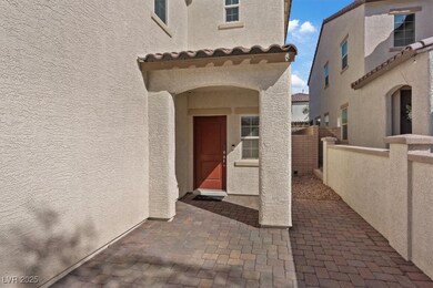 Property entrance with a patio courtyard