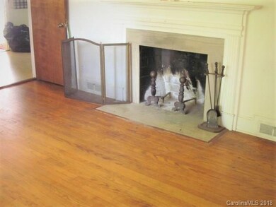 Living room with hardwood floors and wood burning 