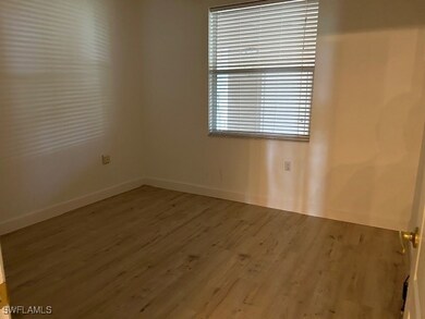 Spare room featuring wood-type flooring