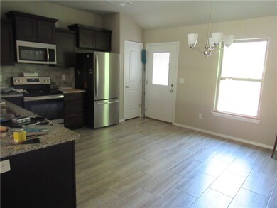 Open kitchen with NEW refrigerator and all other like new appliances.