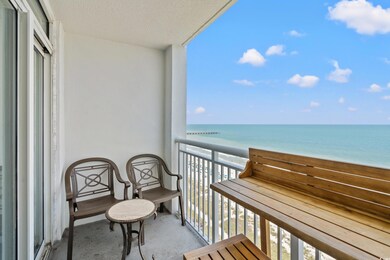 Balcony with view of water and beach