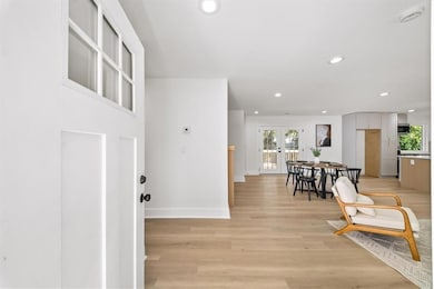 Entryway featuring recessed lighting, light wood-type flooring, plenty of natural light, and french doors
