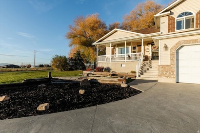 View of front of home with a porch, a garage, a front lawn, driveway, and stairs