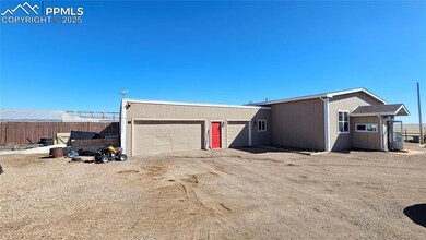View of front facade featuring a garage, driveway,