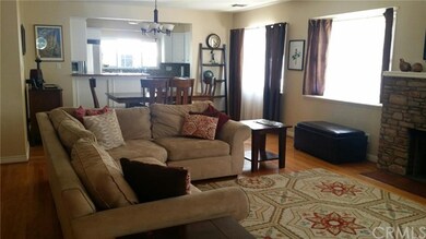 Large living room with fireplace opening to dining