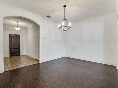 Unfurnished room featuring ornamental molding and dark hardwood / wood-style flooring