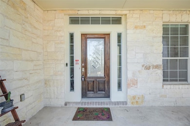 Property entrance with stone siding