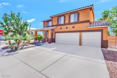 View of front of house featuring stucco siding, driveway, an attached garage, and a tile roof