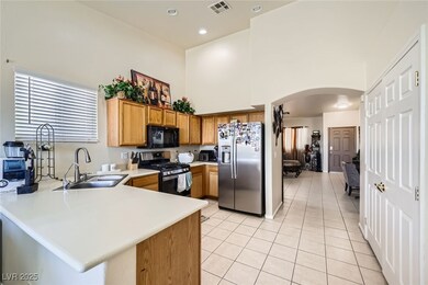 Kitchen with stainless steel appliances, arched wa