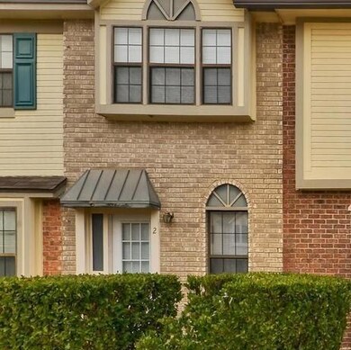 Entrance to property featuring brick siding