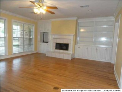 The living area has a wall of built in cabinets an